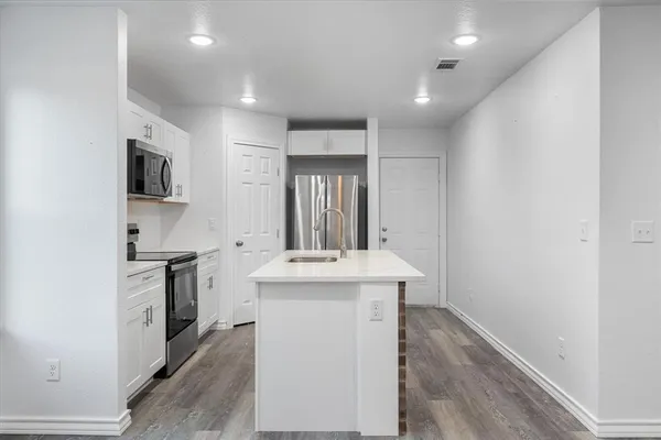 a kitchen with a stove a sink and a refrigerator