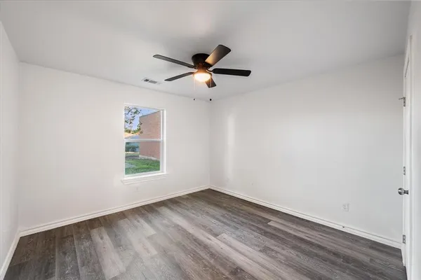 a view of an empty room and wooden floor