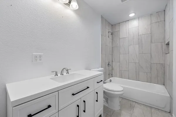 an empty room with window and ceiling fan