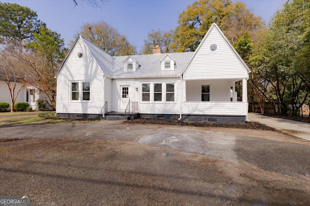 1205 Swift Street Perry, GA 31069 - Photo 1 of 63 a view of a white house with a yard