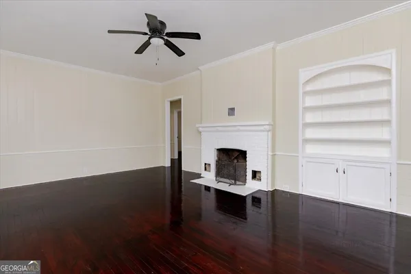 a view of a livingroom with wooden floor and a window