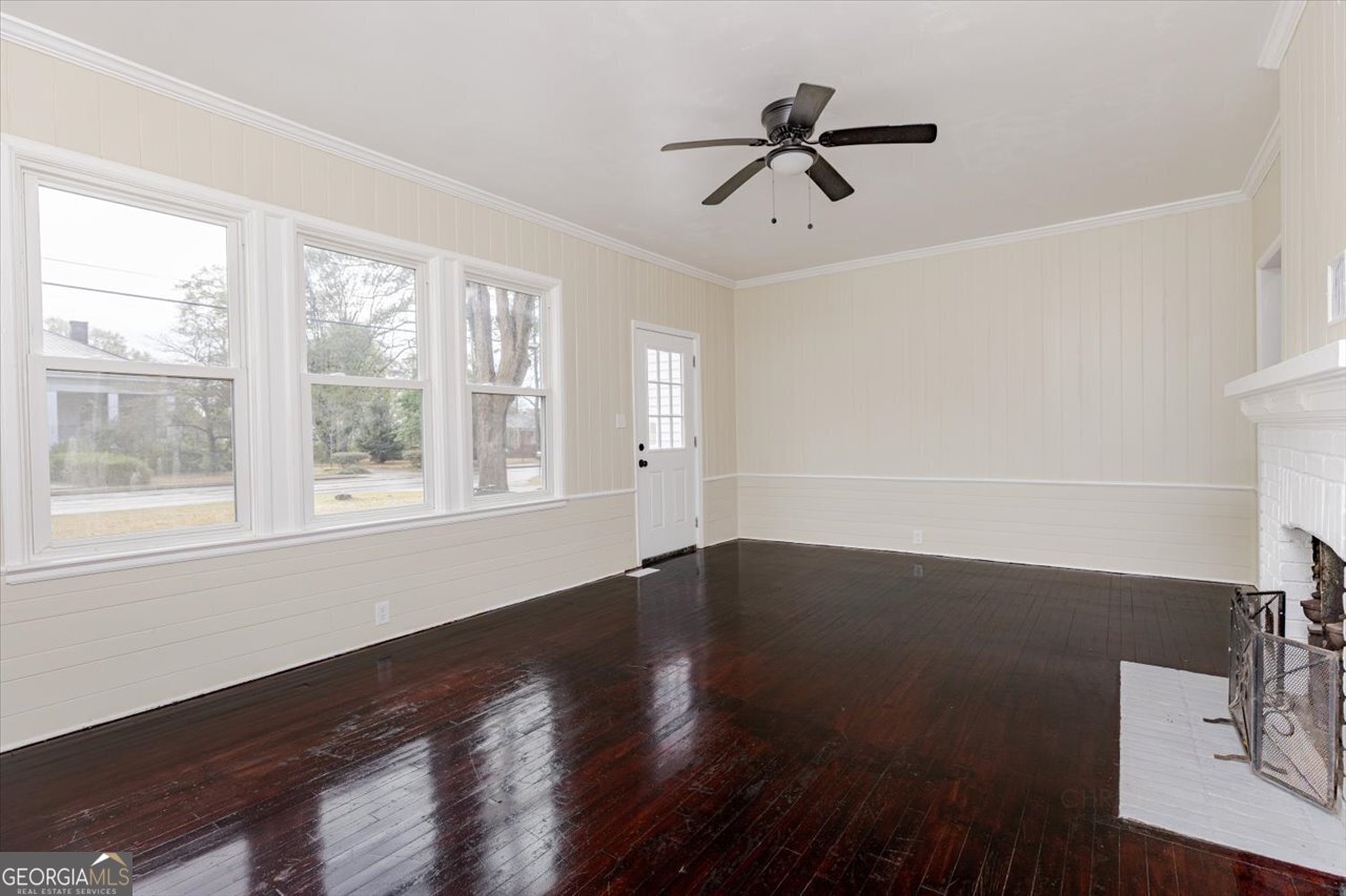 1205 Swift Street Perry, GA 31069 - Photo 12 of 63 a view of an empty room with wooden floor and a window