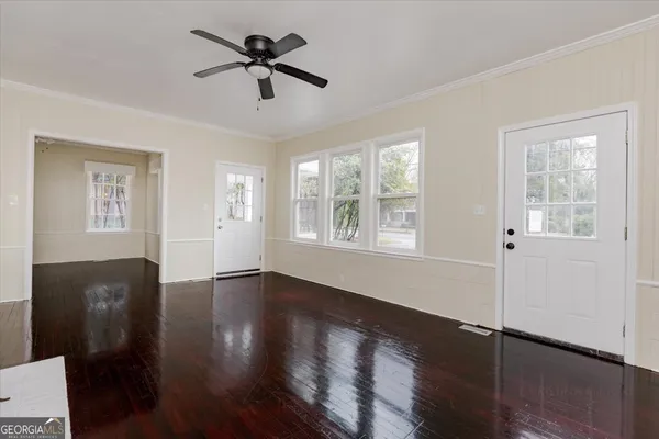 wooden floor in an empty room with a window