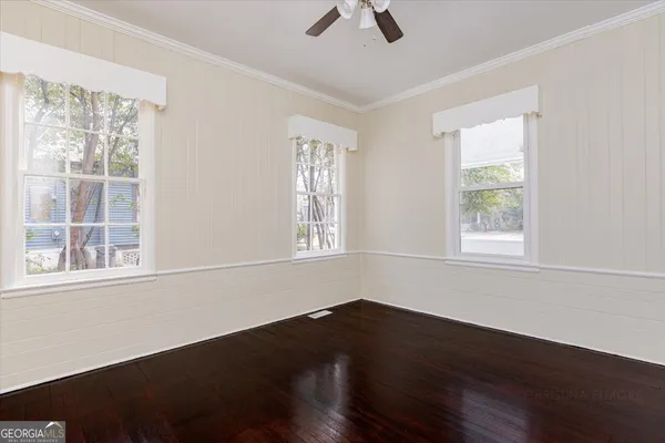 an empty room with windows and closet
