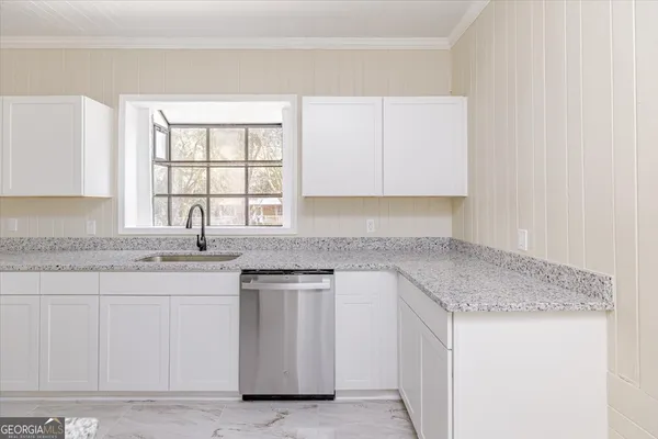 a kitchen with stainless steel appliances granite countertop a stove a microwave and a refrigerator