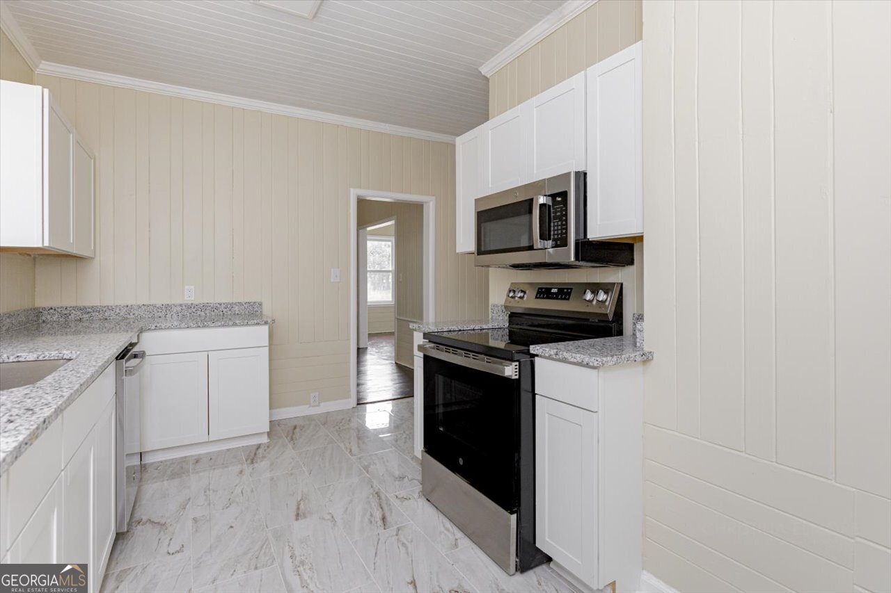 1205 Swift Street Perry, GA 31069 - Photo 24 of 63 a kitchen with a sink and steel appliances