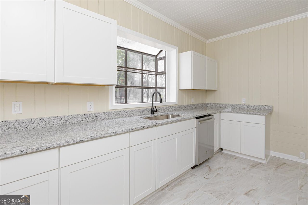 1205 Swift Street Perry, GA 31069 - Photo 26 of 63 a kitchen with granite countertop white cabinets and sink