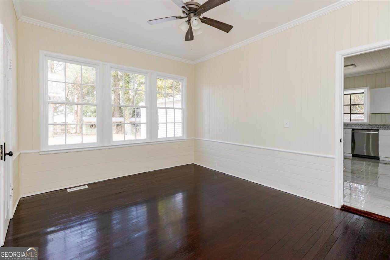 1205 Swift Street Perry, GA 31069 - Photo 32 of 63 an empty room with wooden floor fan and windows