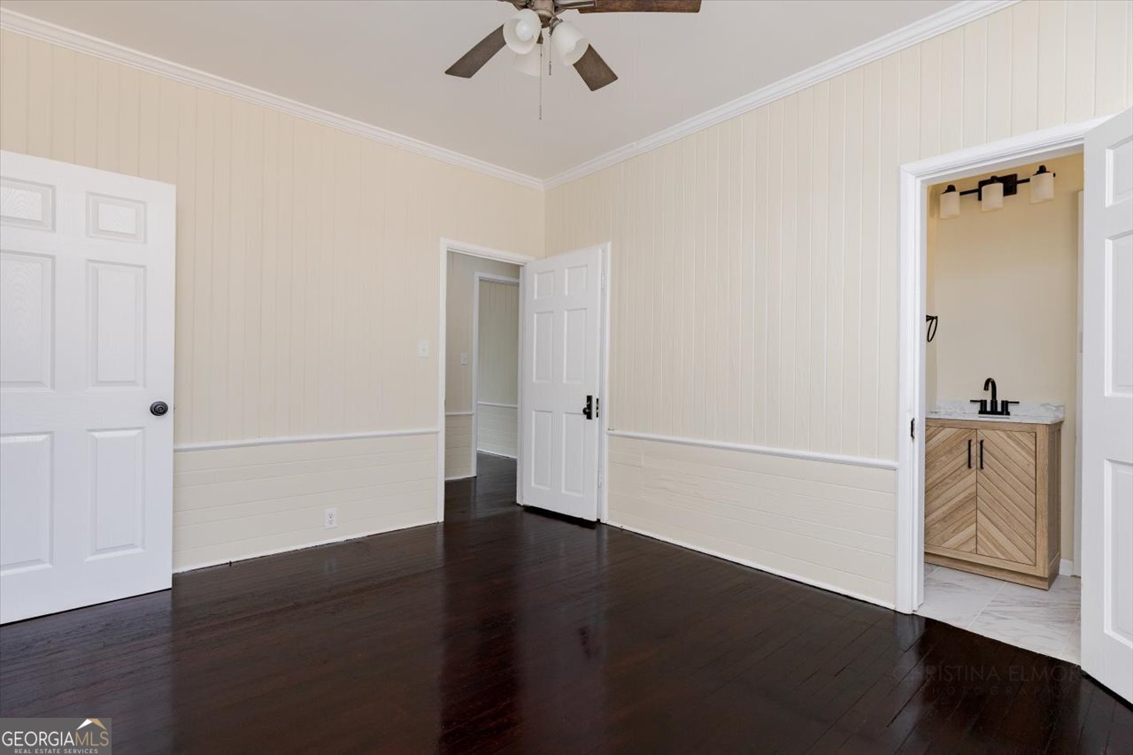 1205 Swift Street Perry, GA 31069 - Photo 34 of 63 an empty room with wooden floor cabinet and windows