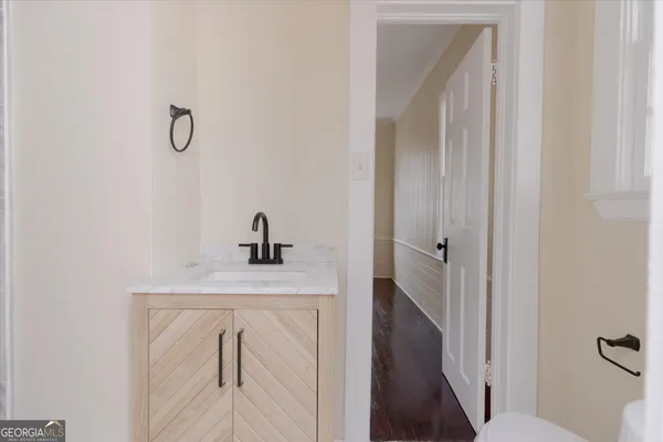 a view of a room with wooden floor and white walls