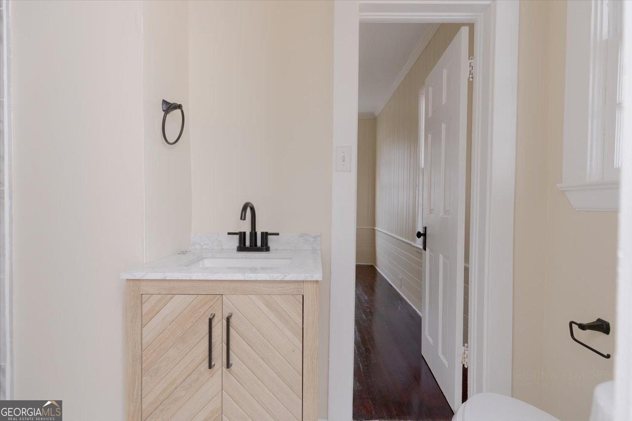 1205 Swift Street Perry, GA 31069 - Photo 35 of 63 a bathroom with a sink a toilet and vanity