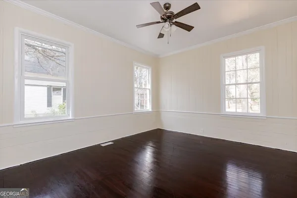 a view of a room with wooden floor and windows