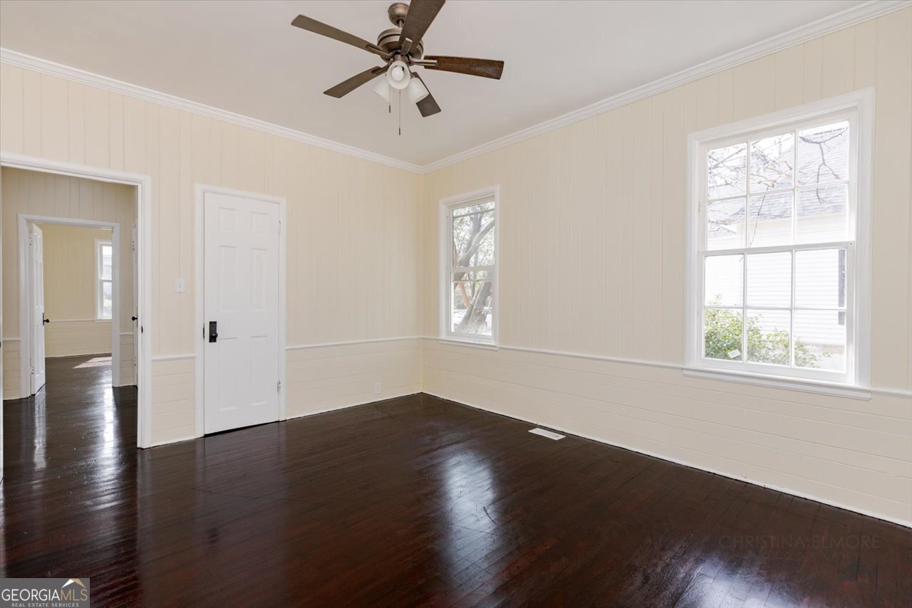 1205 Swift Street Perry, GA 31069 - Photo 39 of 63 a view of an empty room with wooden floor and a window