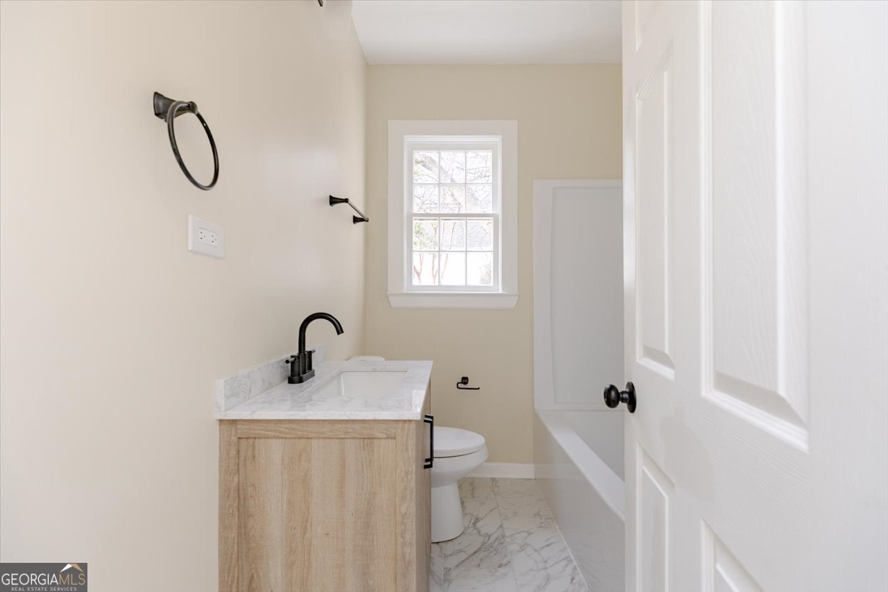 1205 Swift Street Perry, GA 31069 - Photo 42 of 63 a bathroom with a sink a toilet and shower