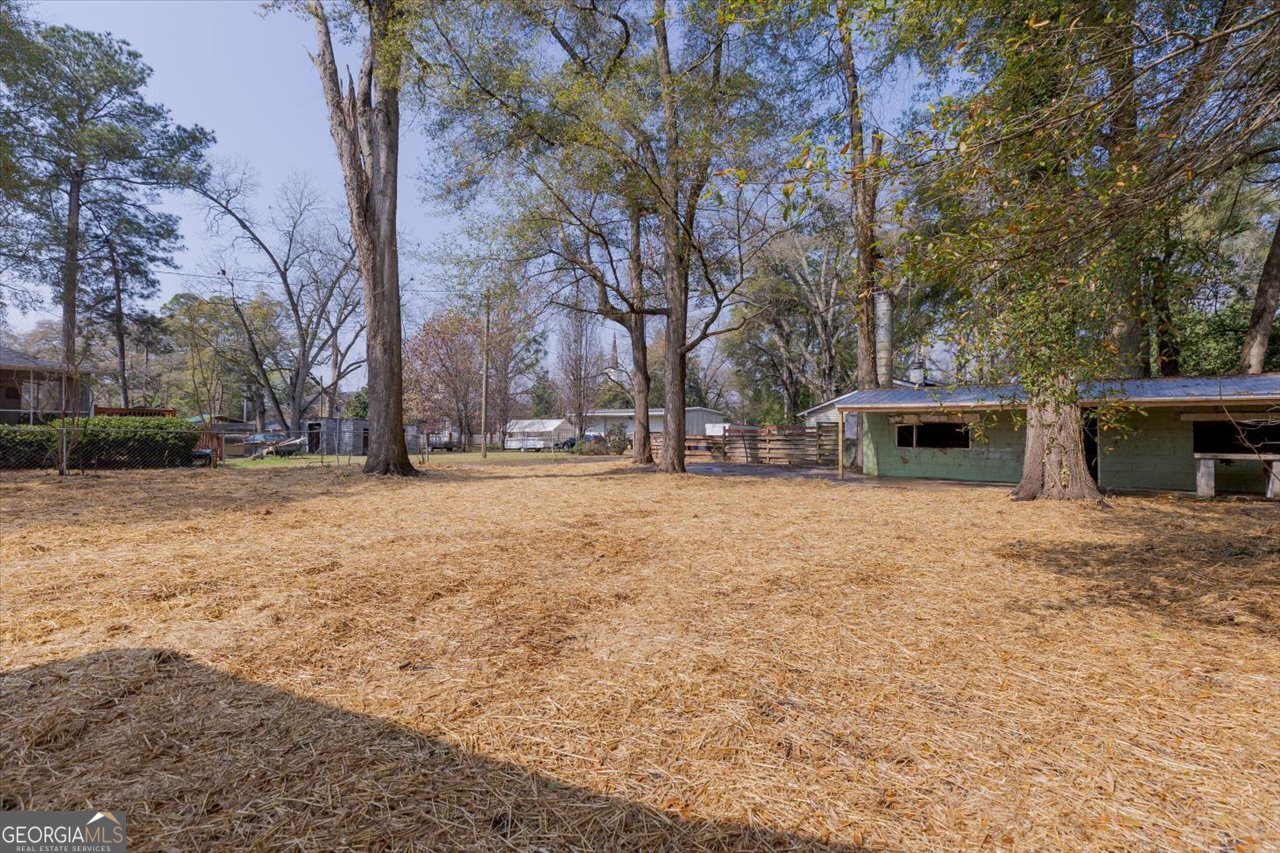 1205 Swift Street Perry, GA 31069 - Photo 60 of 63 a front view of a house with a yard and trees