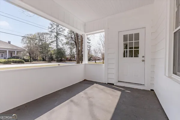 a living room with wooden floor and a fireplace