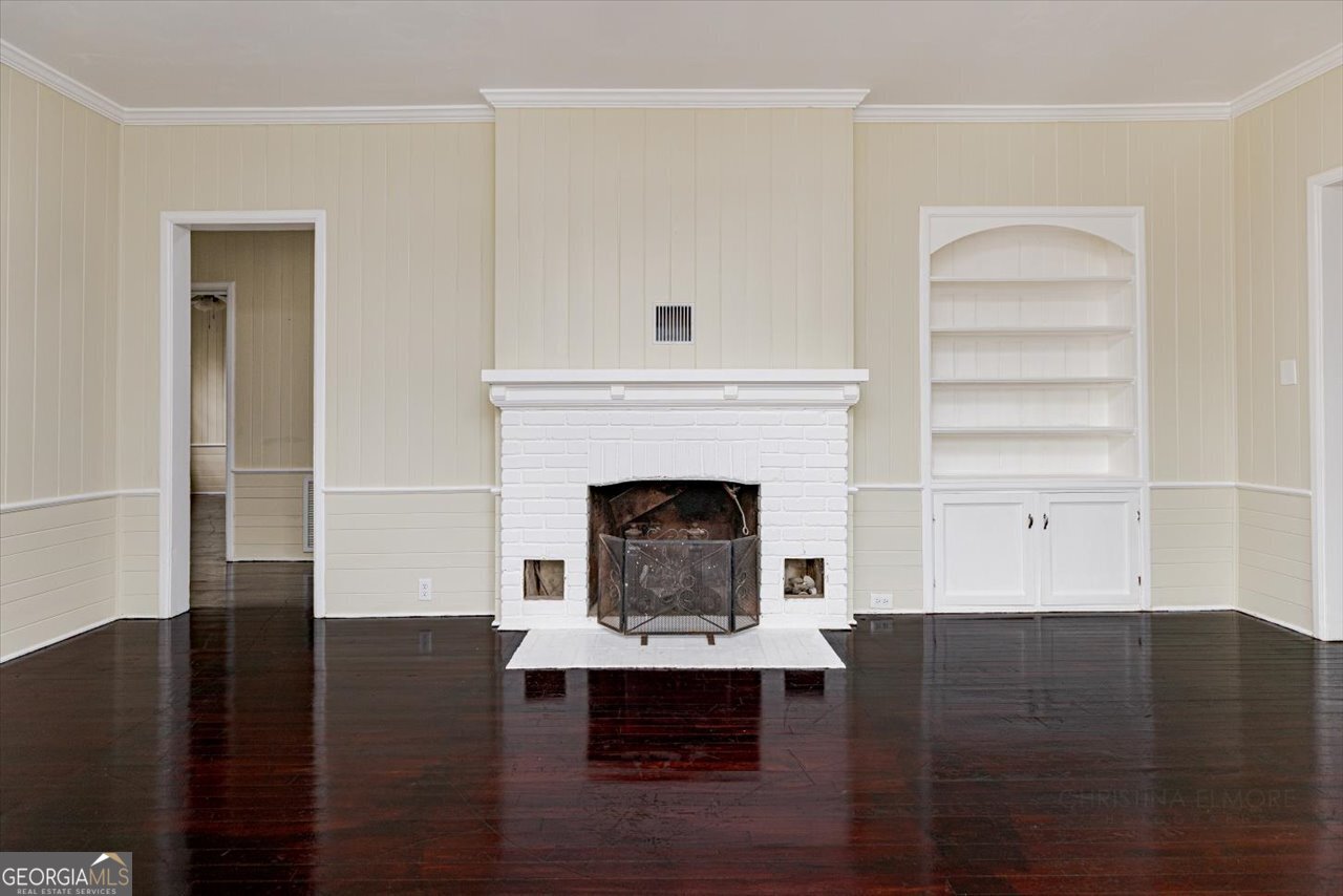 1205 Swift Street Perry, GA 31069 - Photo 10 of 63 a living room with wooden floor and a fireplace