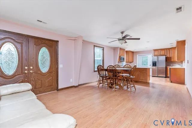 a living room with furniture a clock and a large window