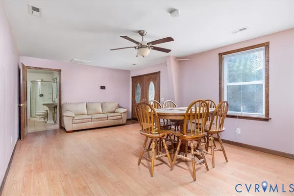 a dining room with furniture and window