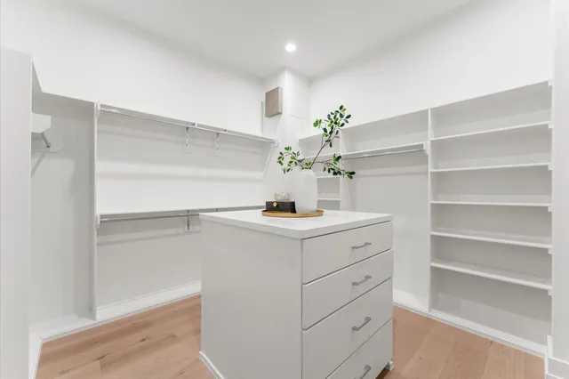 a white bath tub sitting next to a white sink and vanity