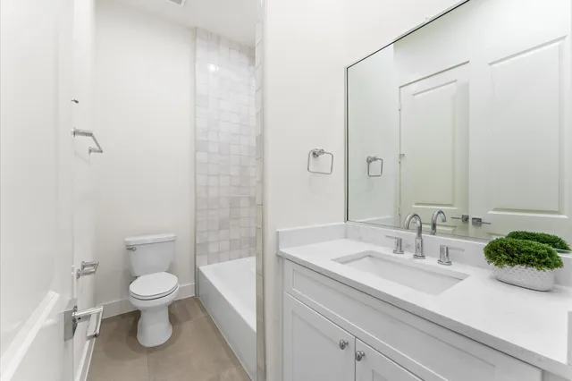 a bathroom with a white bath tub and a shower