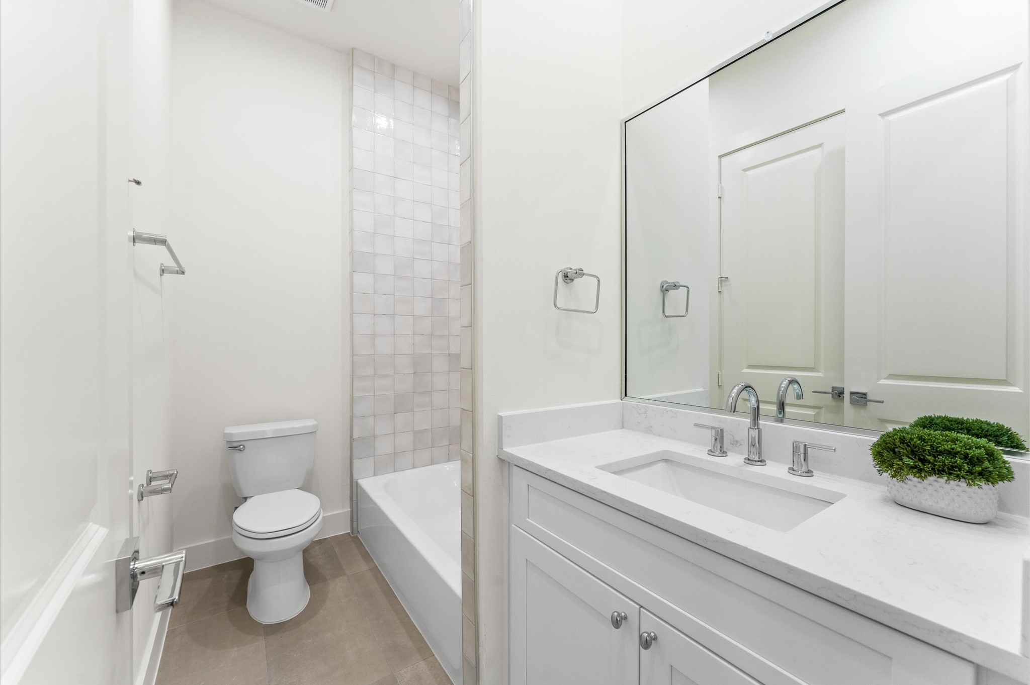 4403 Feagan Street Houston, TX 77007 - Photo 34 of 40 a bathroom with a sink a toilet and a large mirror