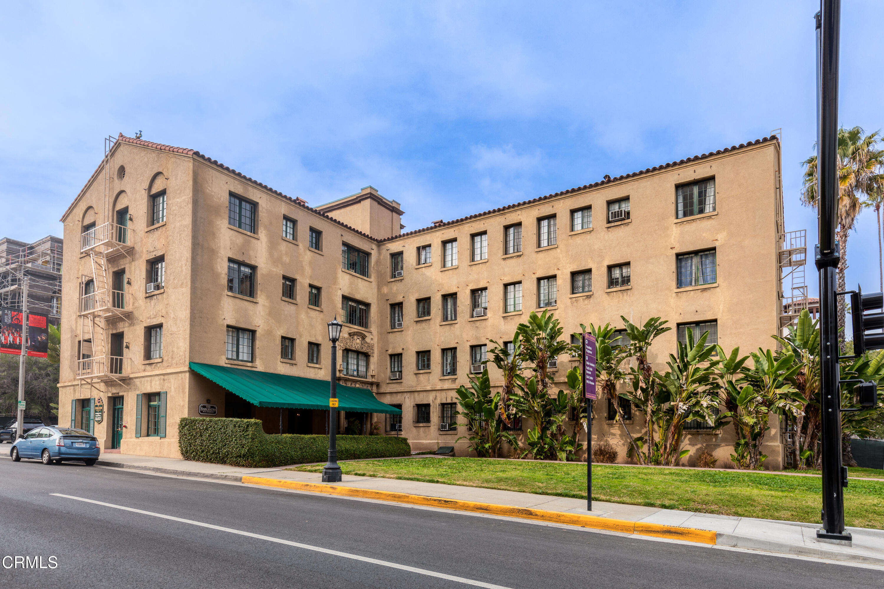 a view of a tall building next to a yard