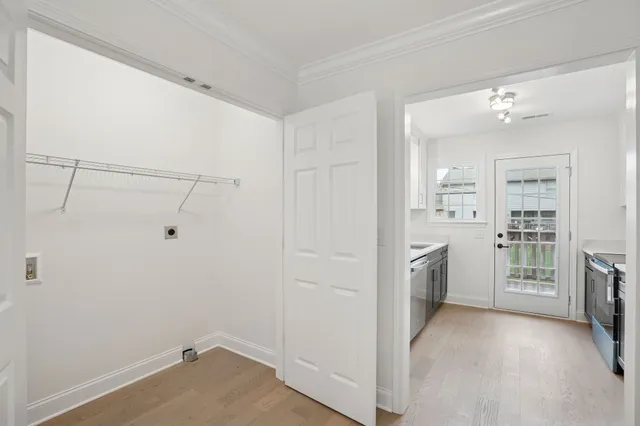 a view of a kitchen with refrigerator and white cabinets