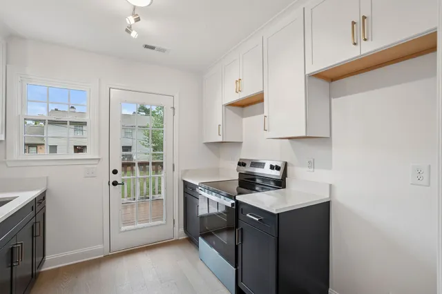 a kitchen with stainless steel appliances granite countertop a stove and a refrigerator