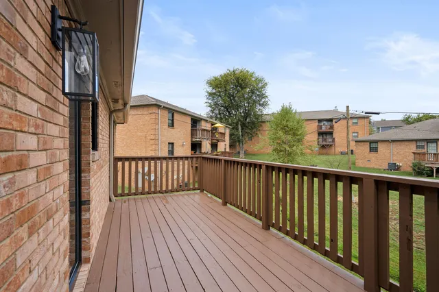 a view of deck with a large window and wooden floor