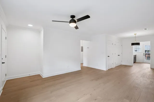an empty room with closet and wooden floor