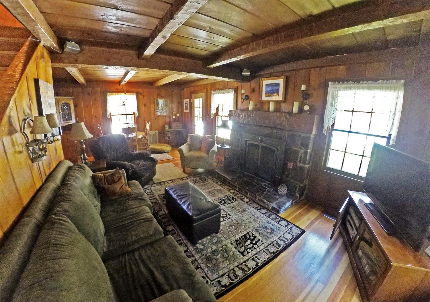 765 Old Ferry Road Shady Cove, OR 97539 - Photo 10 of 32 Living room with hand-hewn beams and man