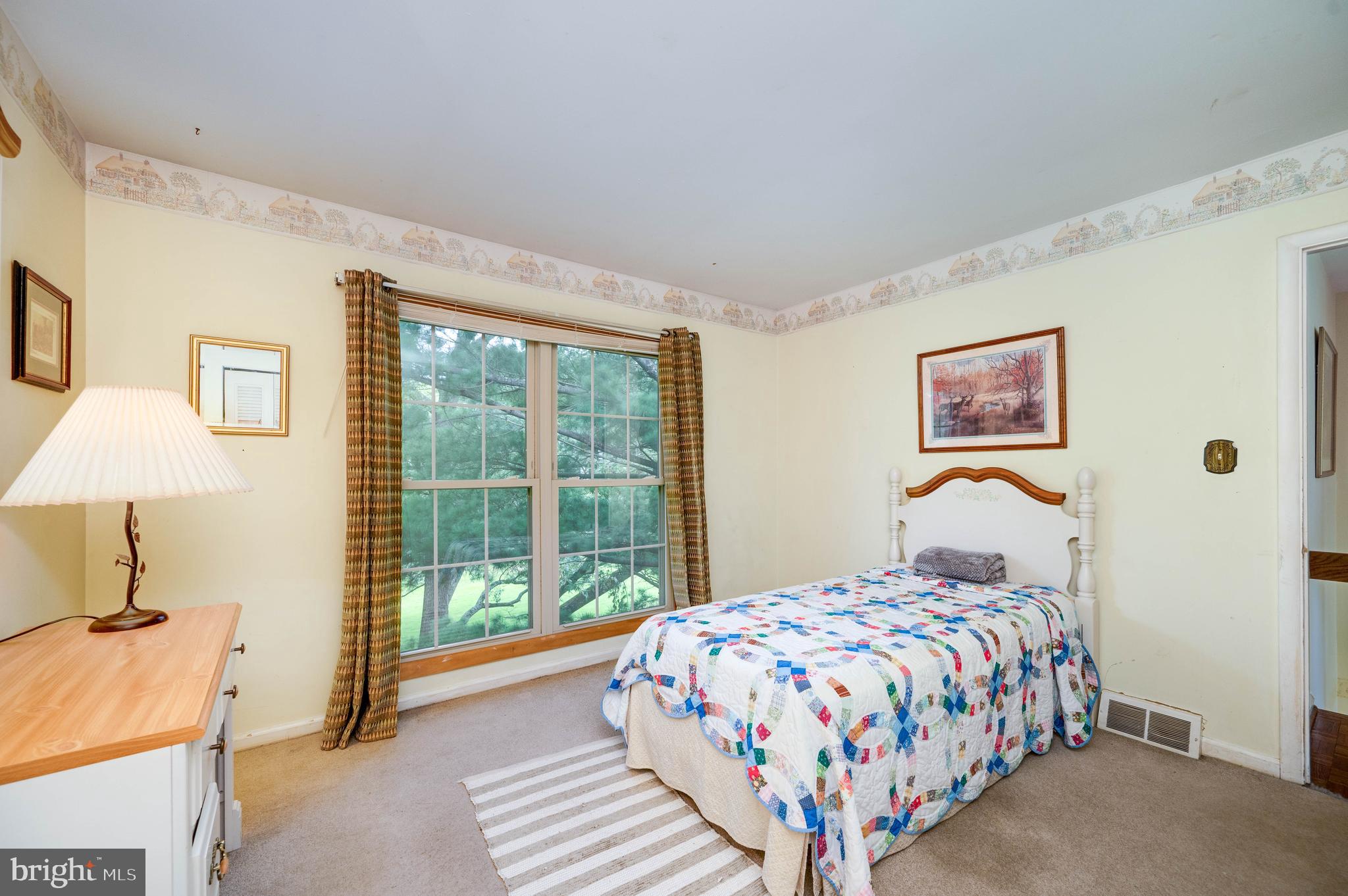 4 Nassau Circle Reading, PA 19607 - Photo 14 of 23 a bedroom with a bed lamp and a large window