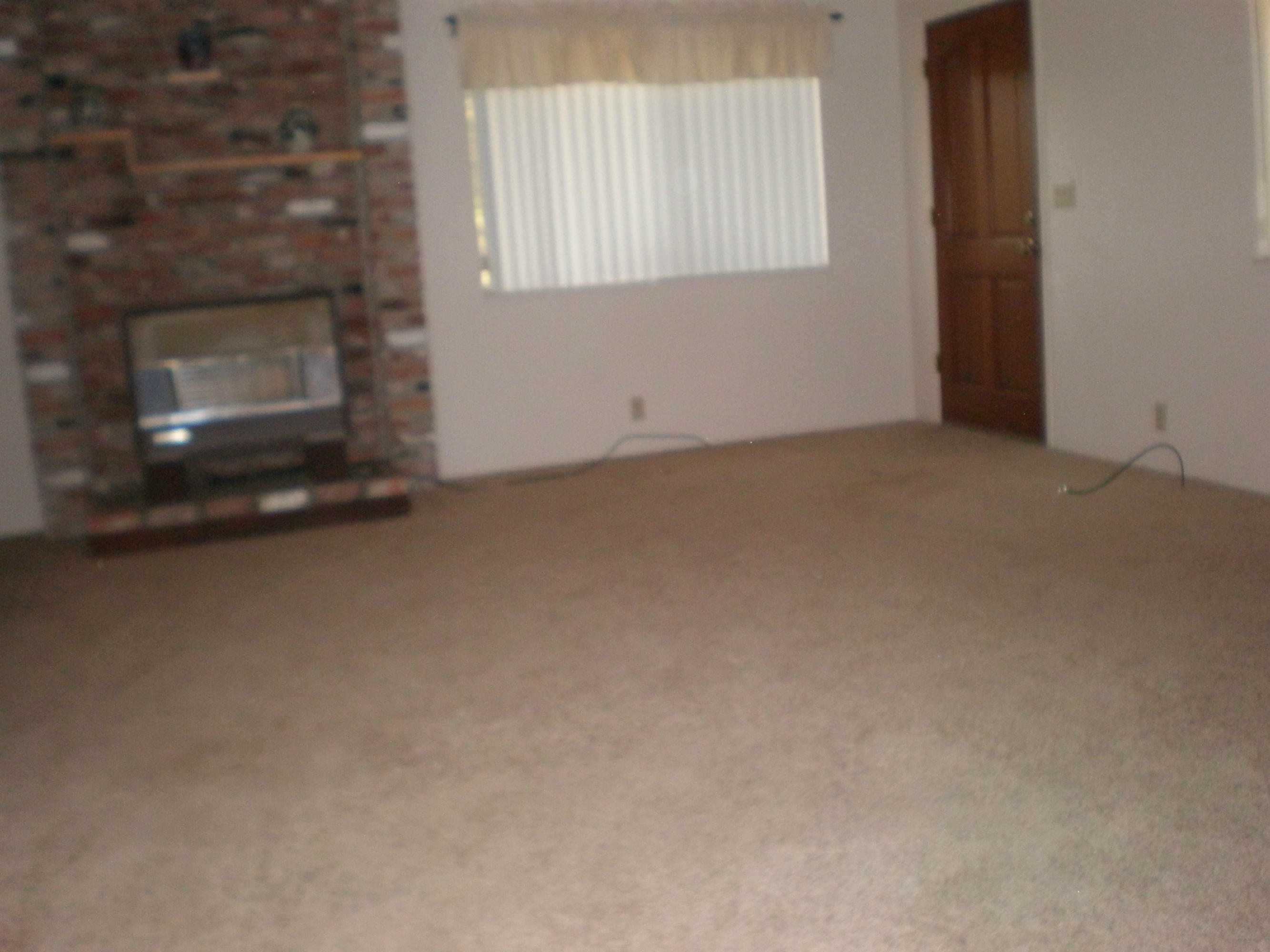 3101 Rancho Road Redding, CA 96002 - Photo 3 of 14 a view of empty room with window and fireplace