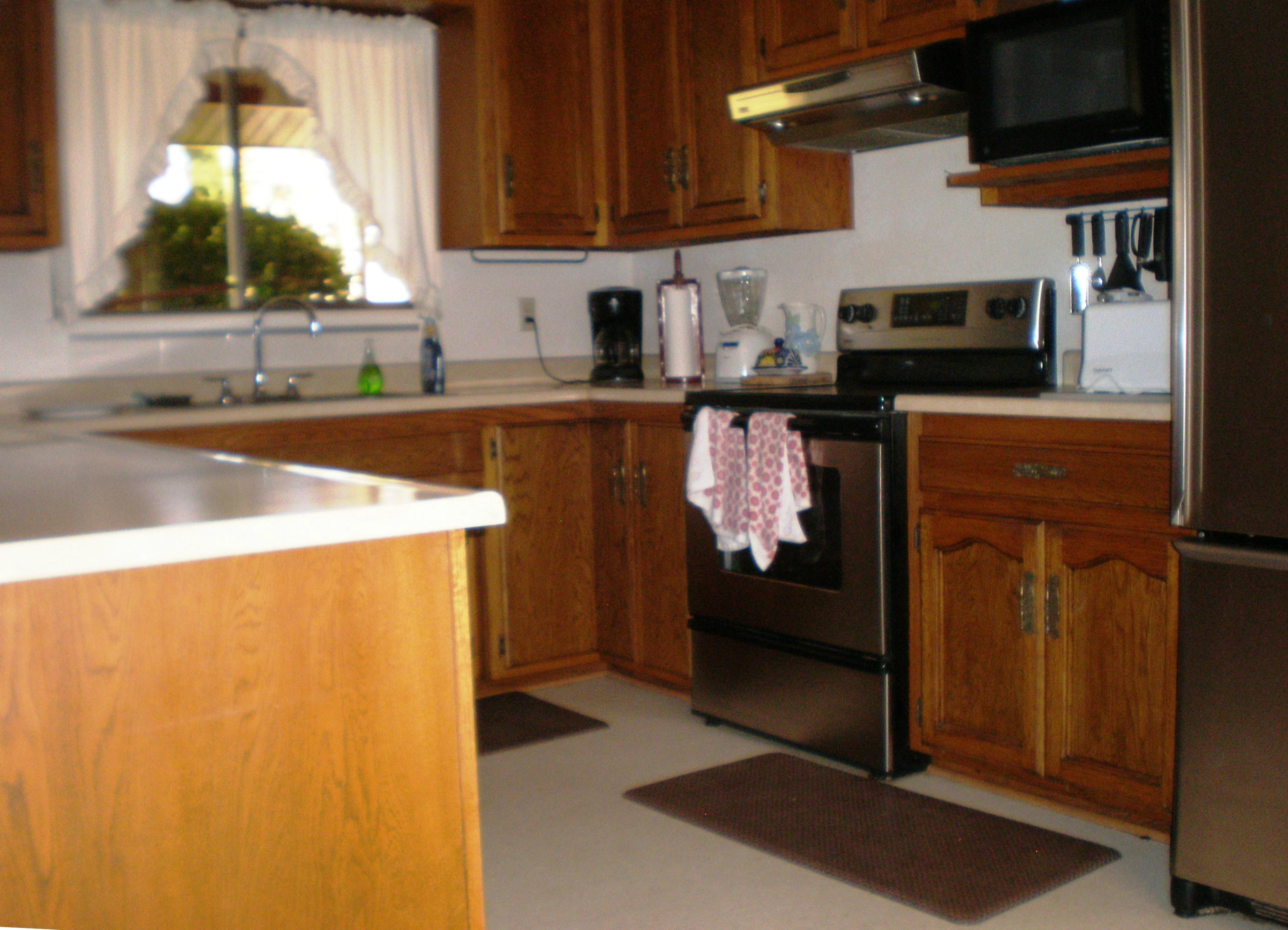 3101 Rancho Road Redding, CA 96002 - Photo 4 of 14 a kitchen with stainless steel appliances a refrigerator and a sink