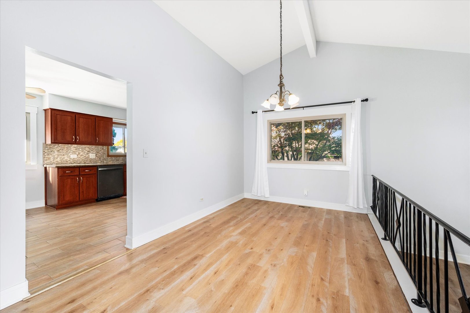 1228 Honey Hill Road Addison, IL 60101 - Photo 11 of 41 a view of kitchen and empty room with wooden floor