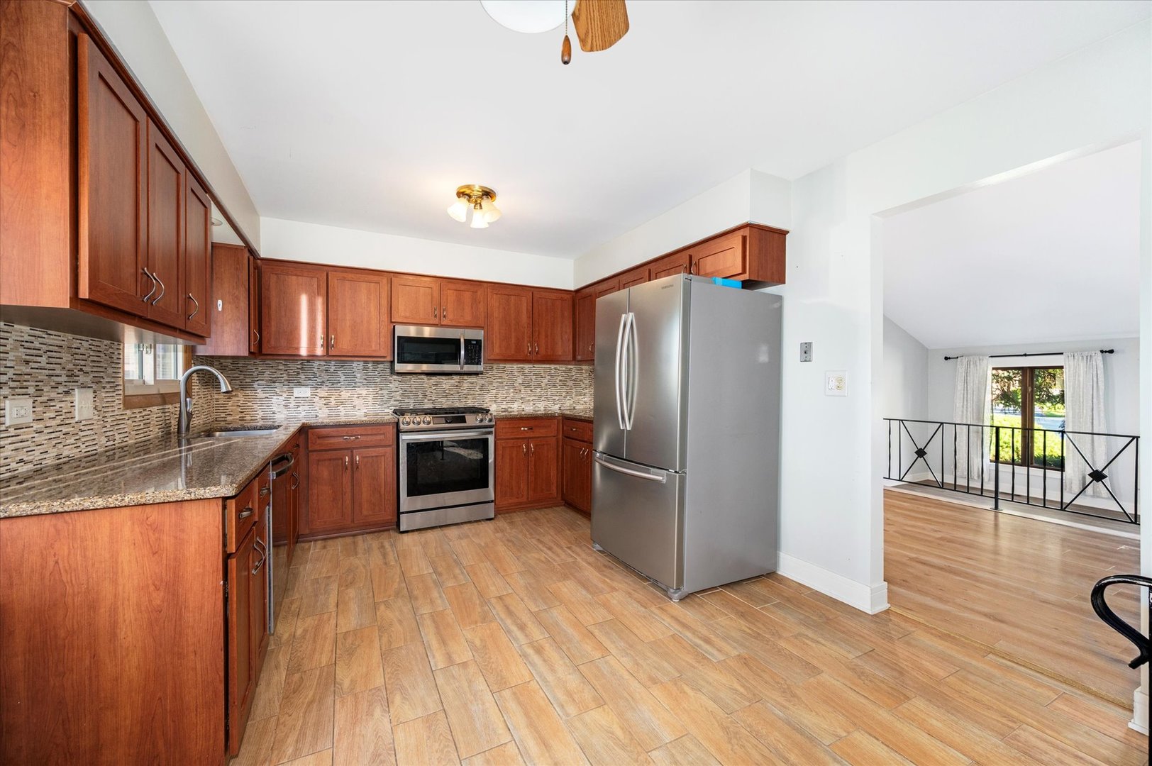 1228 Honey Hill Road Addison, IL 60101 - Photo 12 of 41 a kitchen with stainless steel appliances granite countertop a refrigerator a stove top oven a sink and dishwasher