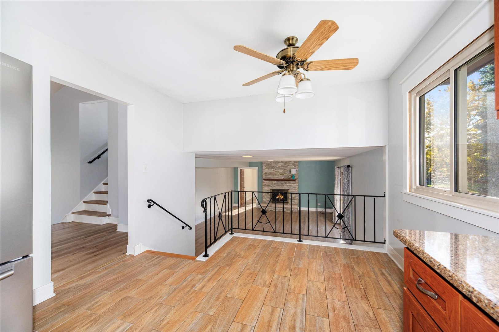 1228 Honey Hill Road Addison, IL 60101 - Photo 14 of 41 a view of empty room with wooden floor and fan