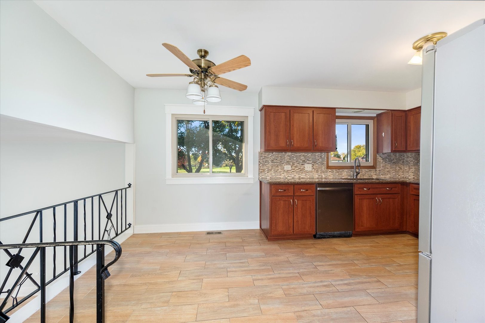 1228 Honey Hill Road Addison, IL 60101 - Photo 15 of 41 a kitchen with stainless steel appliances granite countertop a stove a sink dishwasher and a refrigerator with wooden floor