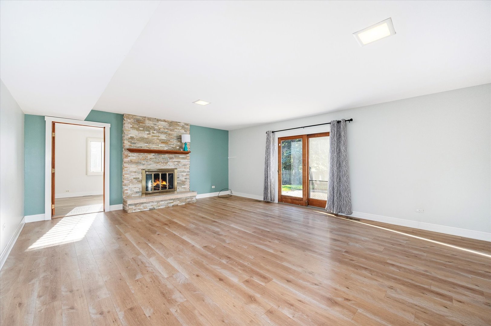 1228 Honey Hill Road Addison, IL 60101 - Photo 17 of 41 a view of an empty room with wooden floor and a window