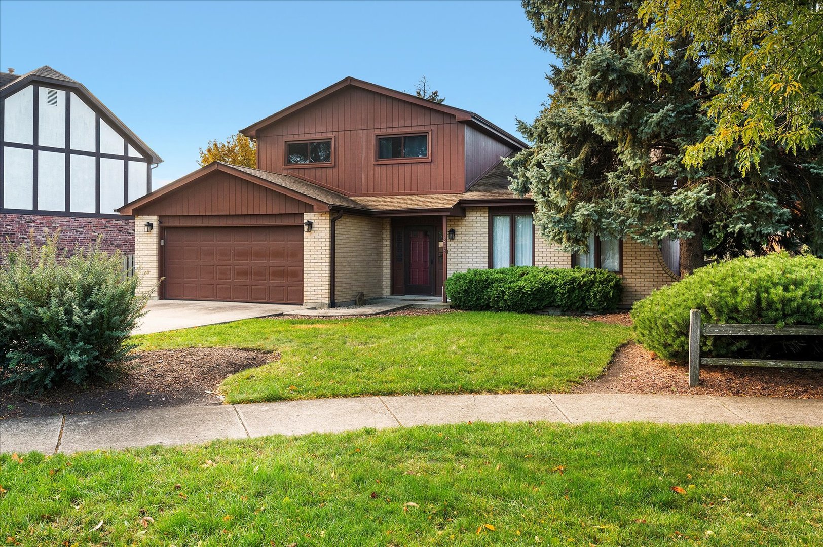 1228 Honey Hill Road Addison, IL 60101 - Photo 2 of 41 a front view of a house with a yard and garage