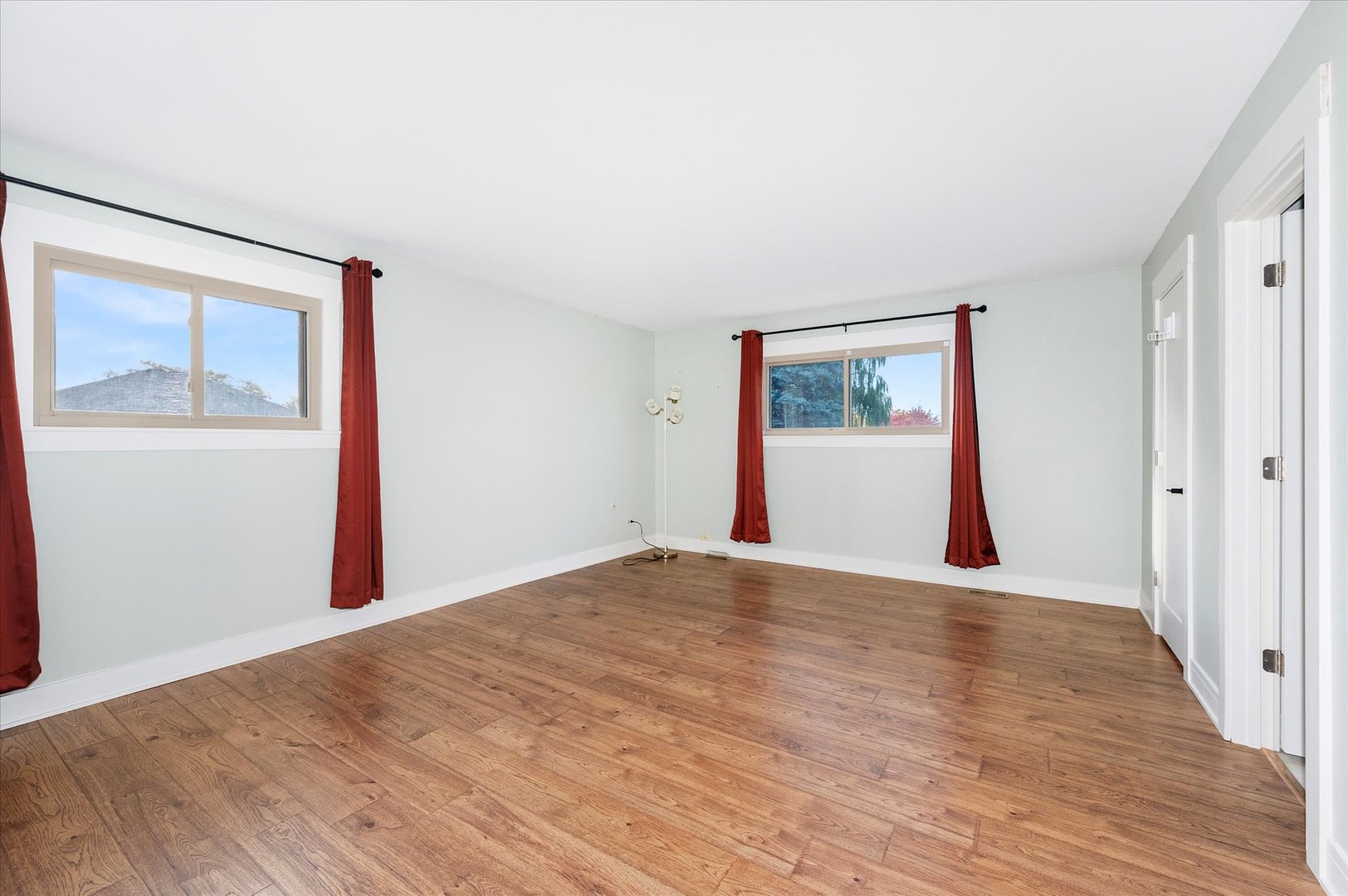 1228 Honey Hill Road Addison, IL 60101 - Photo 27 of 41 a view of an empty room with wooden floor and a window