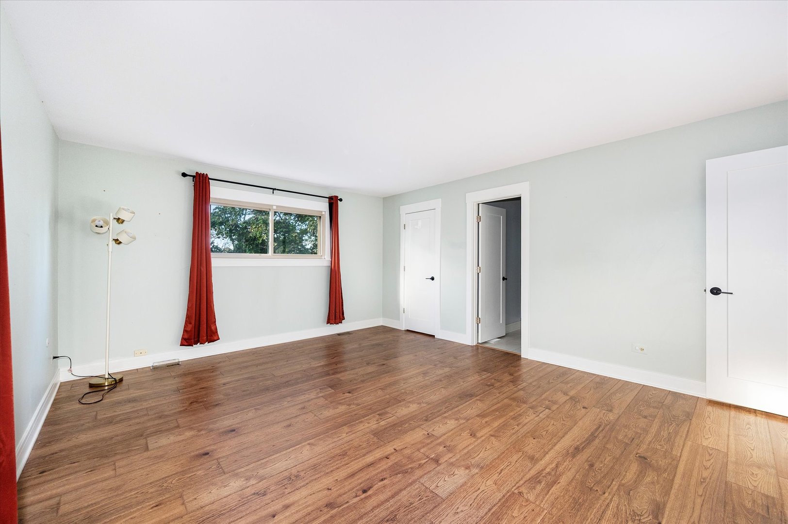 1228 Honey Hill Road Addison, IL 60101 - Photo 28 of 41 a view of an empty room with wooden floor and a window
