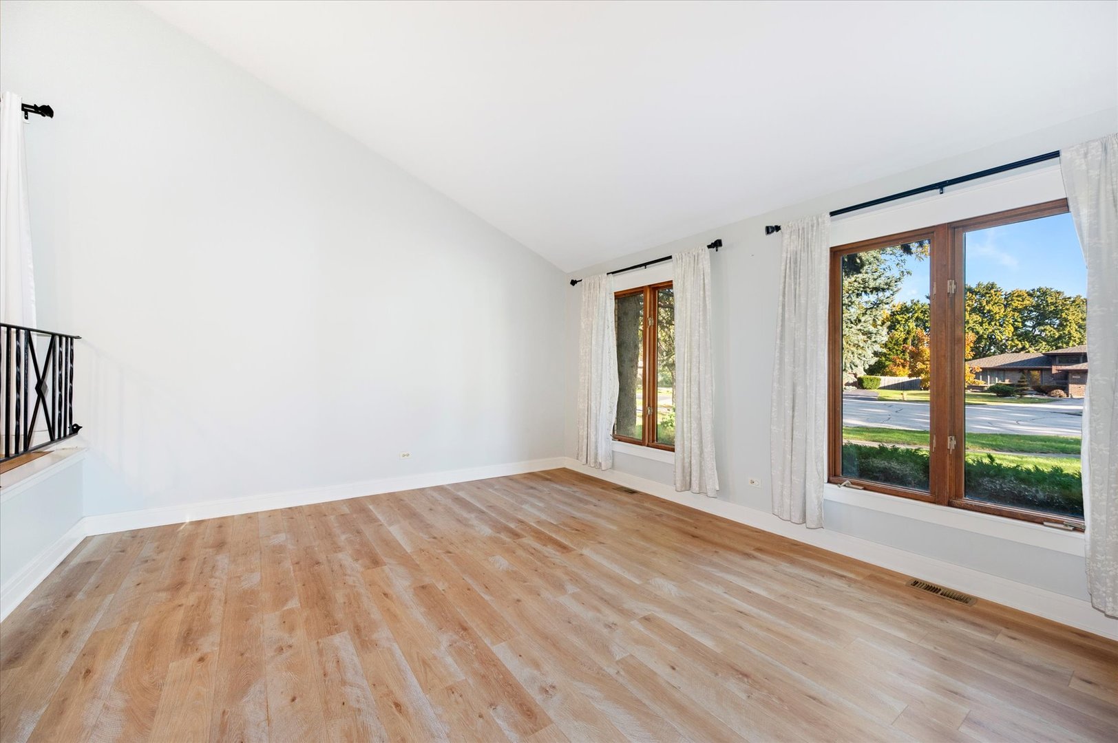 1228 Honey Hill Road Addison, IL 60101 - Photo 6 of 41 a view of an empty room with wooden floor and a window