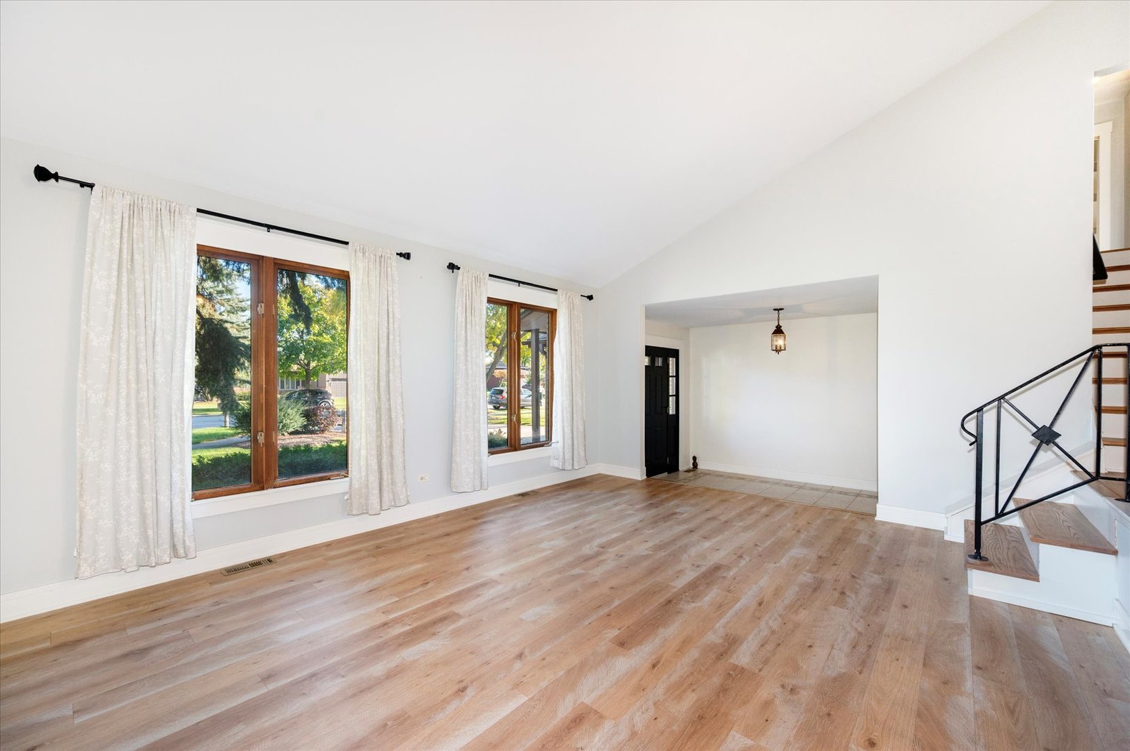 1228 Honey Hill Road Addison, IL 60101 - Photo 9 of 41 a view of an empty room with wooden floor and a window