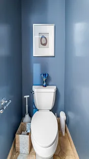 a bathroom with a toilet a sink and a mirror
