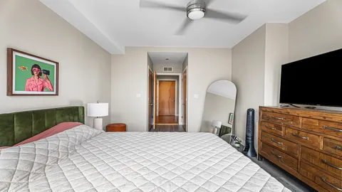 a bedroom with a bed and a flat screen television