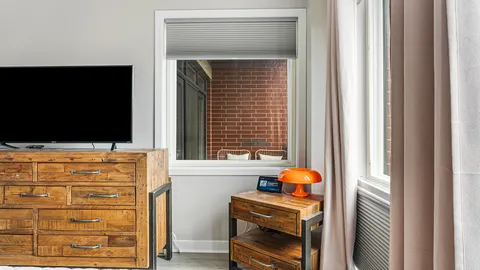 a living room with flat screen tv and a window