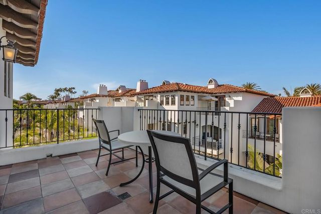 a view of a balcony with chairs