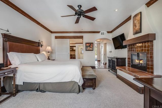 a bedroom with furniture and a fireplace